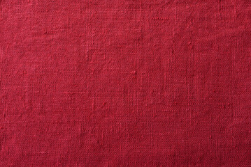 Large red flax seamless background. Rustic linen red artificial rough cloth.