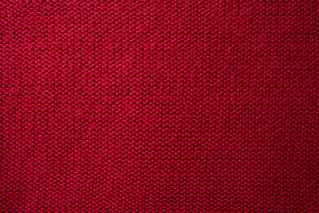 Knitted red pattern closeup. Soft sweater texture, detailed yarn background. Natural woolen fabric,...