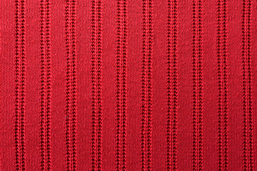 Knitted red pattern closeup. Soft sweater texture, detailed yarn background. Natural woolen fabric,...