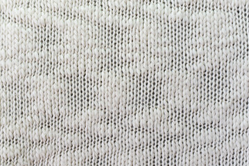 Knitted white pattern closeup. Soft sweater texture, detailed yarn background. Natural woolen...
