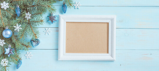 Christmas light blue background, frame for wishes, corner set. Fir branches, blue silver baubles, stars, hearts, cones, white snowflakes. Xmas, New Year festive decoration, top view, copy space.