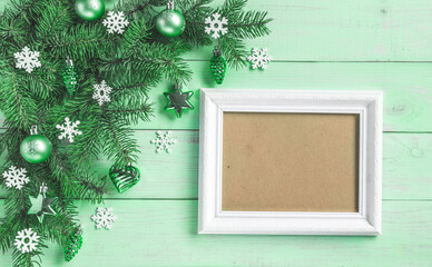 Christmas light green background, frame for wishes, corner set. Fir branches, blue silver baubles, stars, hearts, cones, white snowflakes. Xmas, New Year festive decoration, top view, copy space.