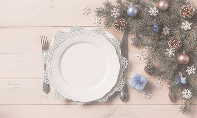 Christmas light table setting, menu concept. Pine tree branches, blue silver baubles, stars, hearts, cones, snowflakes. Christmas festive decoration, corner set. Flat lay, top view, copy space.