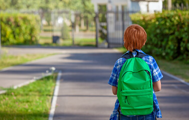 A boy child with a bag goes to elementary school. A primary school child. A student goes to study with a backpack. Back to school