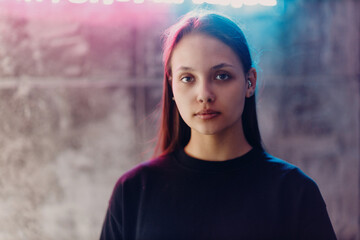 Young woman portrait piercing at beauty studio salon neon light