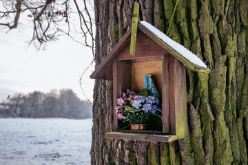 Roman catholic shrine on a tree in Rogow, Lodz Province of Poland