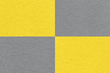 Texture of craft gray and yellow paper background with cells pattern, macro. Structure of vintage...