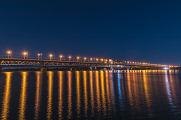 Fototapeta na wymiar Classic panoramic view of the bridge. Bridge across the Dnieper river in the Ukrainian city of Dnepropetrovsk, Dnipro, Ukraine