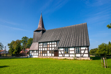Fototapeta na wymiar Half-timbered church of the Assumption of the Blessed Virgin Mary in Lotyn, Greater Poland Voivodeship, Poland