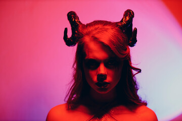 Beautiful young woman with makeup zodiac signs of Capricorn or Aries or Taurus. Girl with horns on...