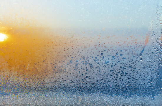 background of window glass with drops in sunlight