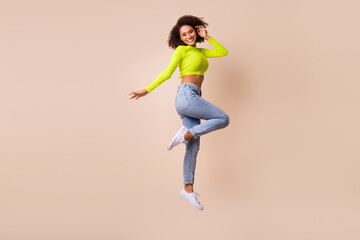 Full length body photo of young smiling adorable girl dancing jump celebrate healthy mestruation isolated on beige color background