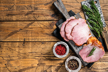 Cold Smoked pork sirloin meat with herbs on rustic board. Wooden background. Top view. Copy space