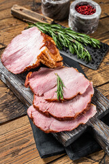 Cold Smoked pork sirloin meat with herbs on rustic board. Wooden background. Top view