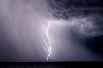 Fotobehang Lightning bolts strike during a thunderstorm in Florida. © jctabb