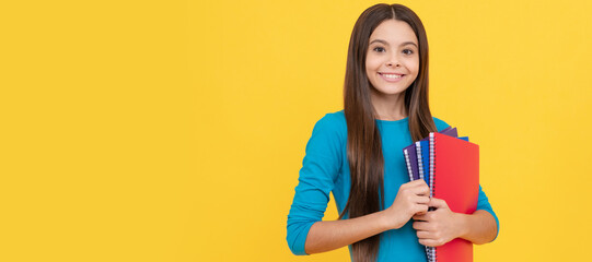 happy teen girl wuth school notebook for making notes. Portrait of schoolgirl student, studio banner header. School child face, copyspace.