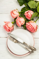 Romantic dinner table on white wooden background. Love concept for Valentine's or Mother's day