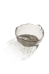 Close-up shot of a gray glass salad bowl with asymmetrical design and a gold rim edge. The empty...