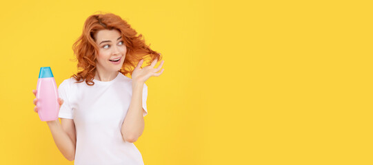 Beautiful woman with organic shampoo over light yellow background. curly hair. Woman isolated face portrait, banner with copy space.