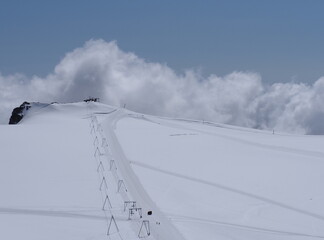 Clouds and ski lift near Castor mount in canton Valais in Switzerland