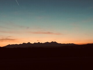 sunset behind mountains