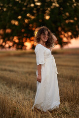 Fototapeta na wymiar Caucasian woman in a field at sunset