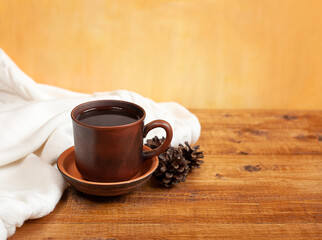 a cup of coffee, a white plaid and cones on a yellow background