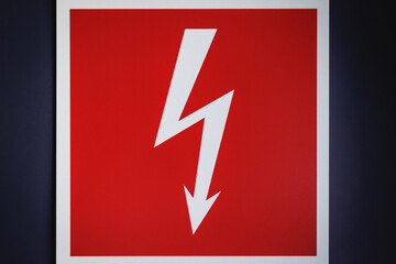 White bolt - electricity sign on a red background with white frame