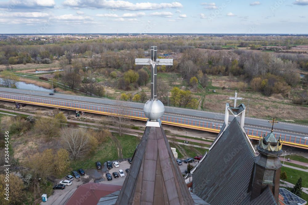 Wall mural Cross on a tower of Siekierki Sanctuary of Our Lady and Trasa Siekierkowska street in Warsaw, Poland