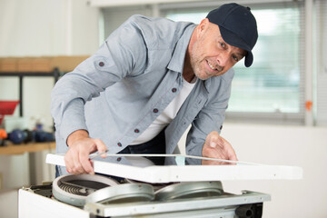 man fixing something in the kitchen