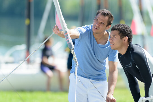 young man preparing to go sailing - Powered by Adobe