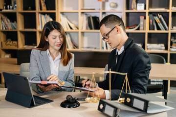 Asian business team and lawyers discussing contract papers sitting at the table. Concepts of law, advice, legal services. at office.