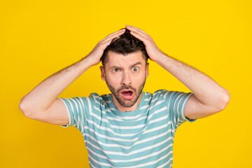 Fototapeta na wymiar Closeup photo of young attractive guy make grimace hands hold head unexpected shock isolated on yellow color background