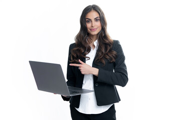 Portrait of a young happy business woman with a laptop over gray background.
