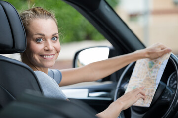Fototapeta na wymiar happy woman got lost while driving a car