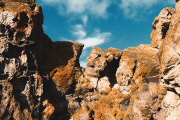 Coastal Beauty: Brown Rocks and Cloudy Sky