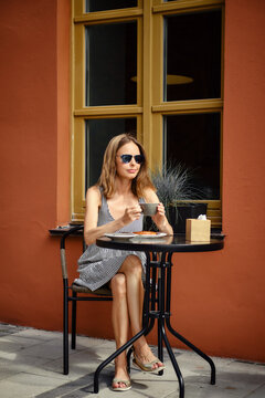 Cute woman waiting for someone at caffe terrace