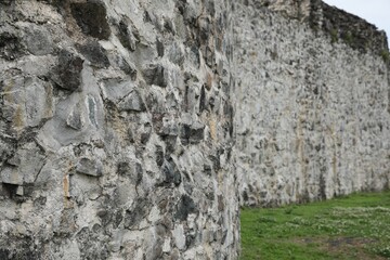 Grey stone wall of old building outdoors