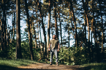 Obraz premium Handsome man standing in forest