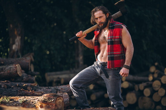Male lumberjack  with an axe in forest
