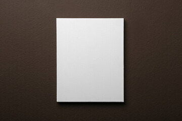 Blank canvas on brown wall. Space for design