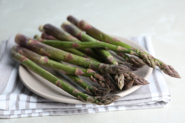 Fresh raw asparagus on table, closeup view