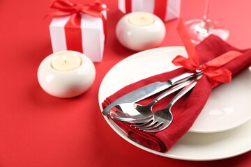 Beautiful table setting for Valentine's Day on red background