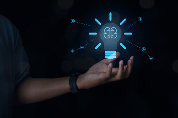 Businessman holding glowing light bulb with symbol brain and creative thinking ideas.