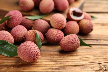 Fresh ripe lychee fruits on wooden table