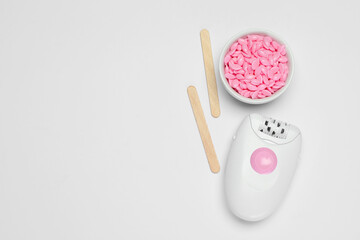 Modern epilator, sticks and wax on white background, flat lay. Space for text - obrazy, fototapety, plakaty