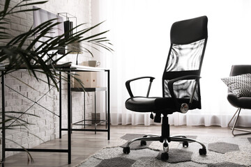 Comfortable chair near desk in modern office interior