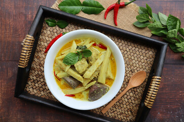 Green curry with chicken - Thai  food at top view on served on bamboo tray , In Thai called Kang Keow Wan Kai