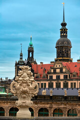Fototapeta premium Decorative vase on the upper gallery of Zwinger complex with the city view at the background, Dresden