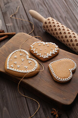 Delicious heart shaped Christmas cookies on wooden table